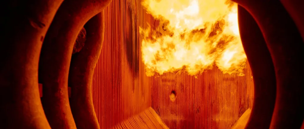 A fire burns inside a burner